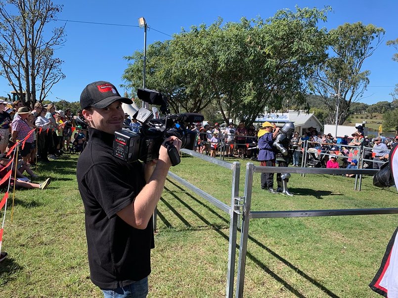 A videographer is happy to be videoing the medieval duel at the Toowoomba Royal Show