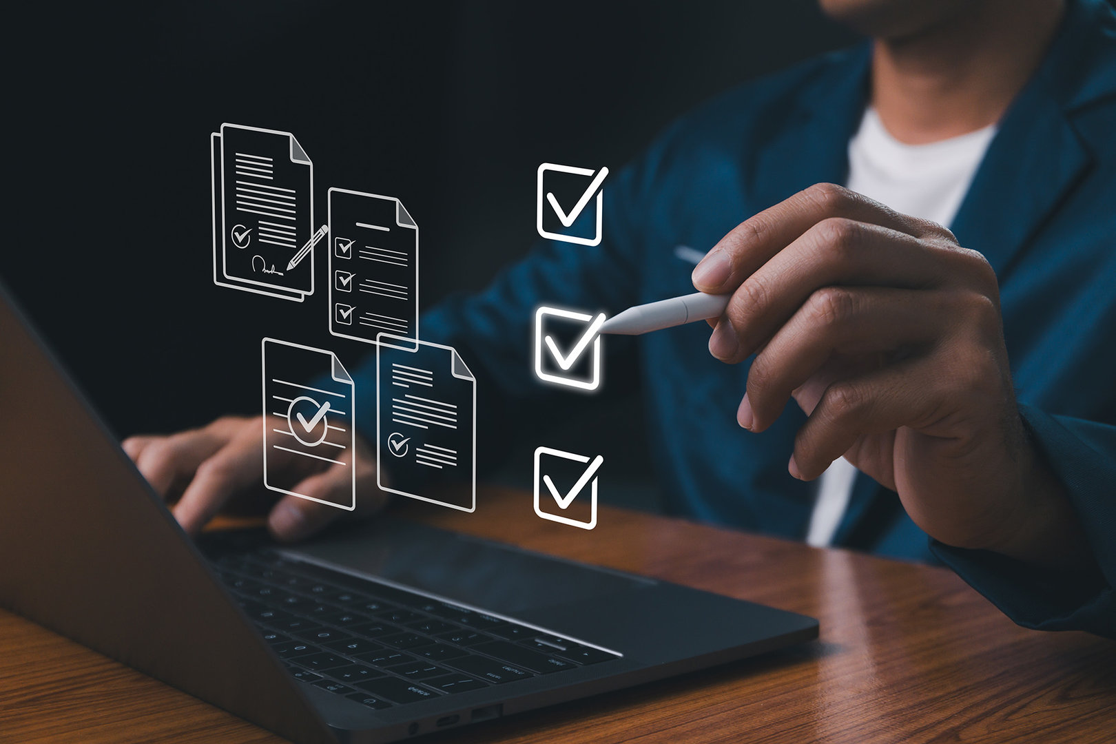 Businessman marks hologram checkboxes floating above his laptop