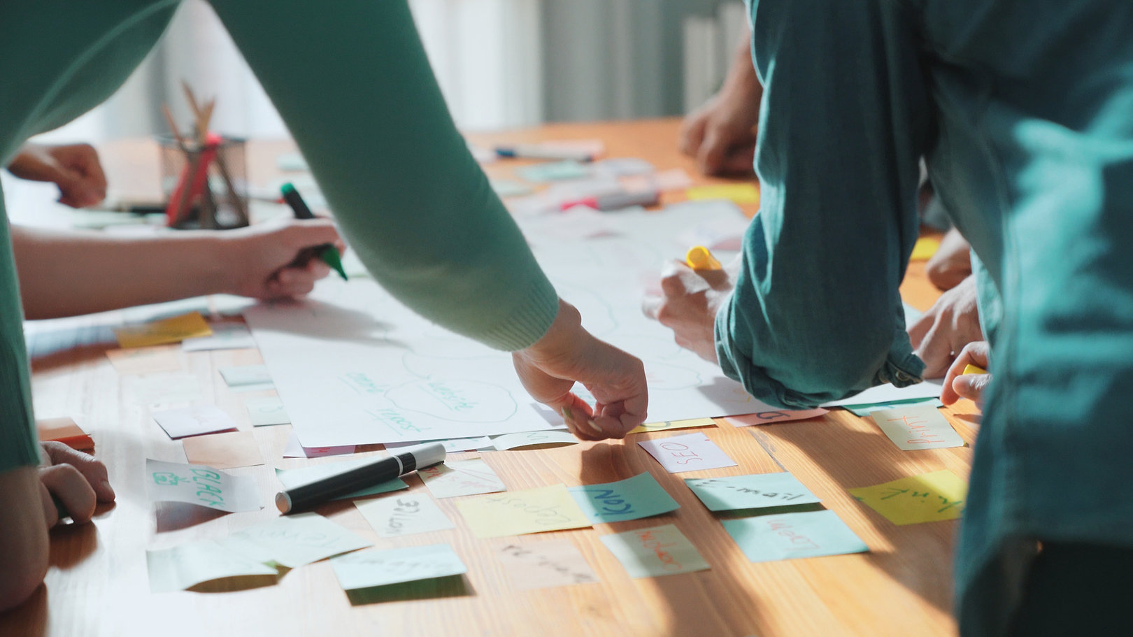 Marketing team collaborating on a project using sticky notes
