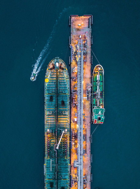 Aerial view of a large cargo ship at a loading dock