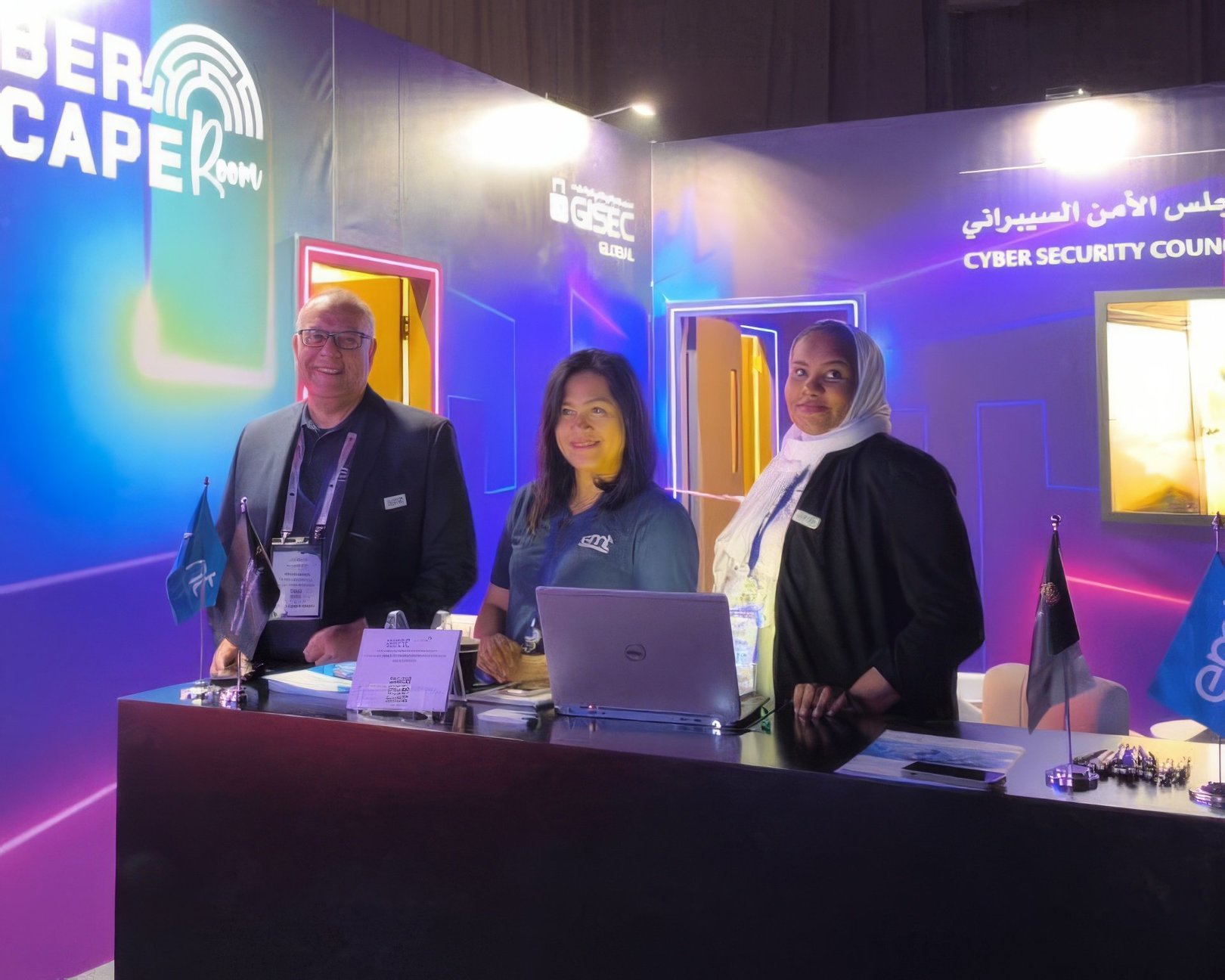 Three people stand at a desk in an escape room. The space is lit with purple and blue neon lights