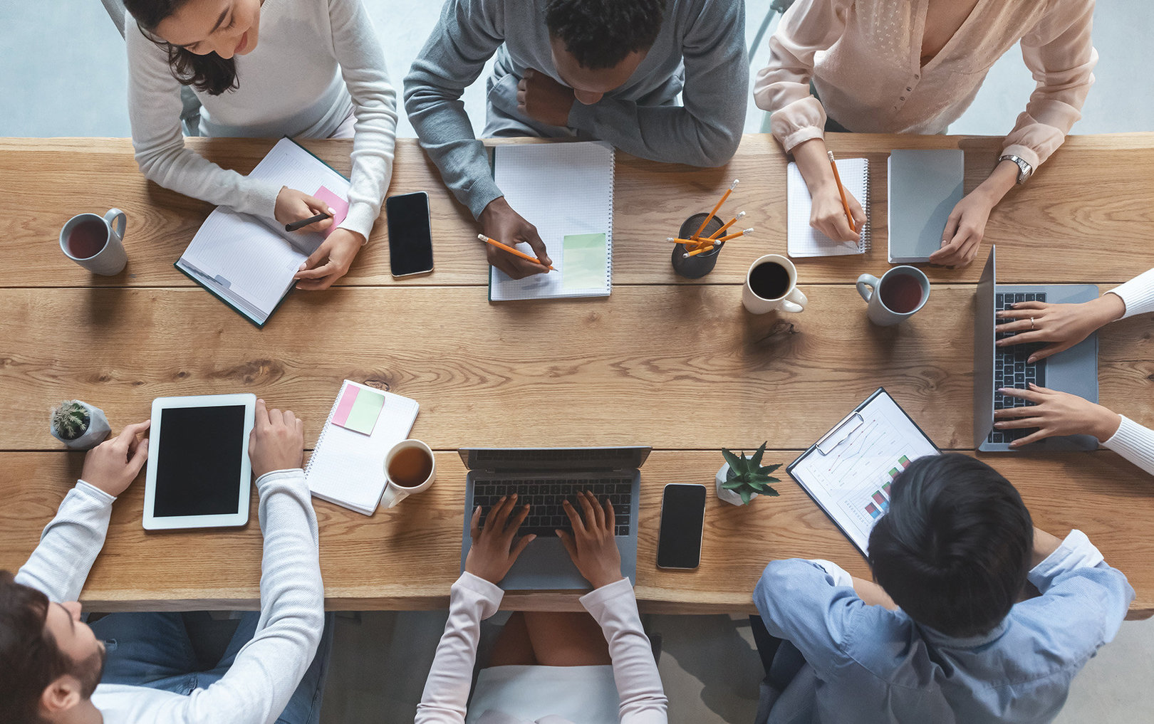 Marketing team collaborating around a wooden table